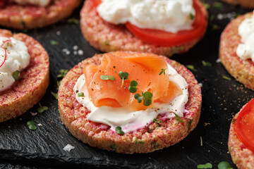 Lentil and pea protein veggie crispy cakes with cottage cheese, beetroot, tomatoes, radishes, cucumber and salmon