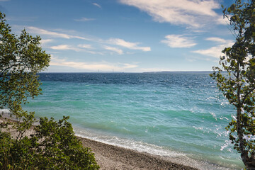 clear blue water on pebble beach
