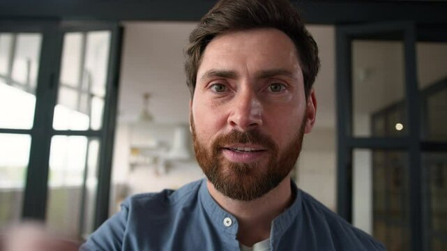 POV webcam smiling positive Caucasian man parent touching mobile phone screen happy male father dad surfing Internet web online at home guy using app swiping display smartphone device touchscreen view