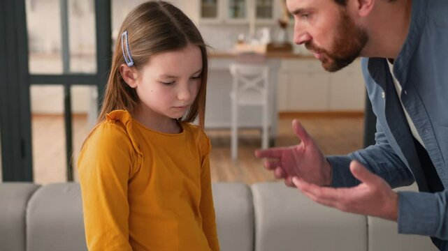 Angry Caucasian man guy speak shouting at guilty daughter little kid family conflict at home annoyed parent father punish naughty little child girl quarrel male dad taking away mobile phone discipline