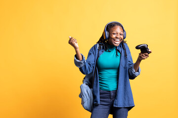 Overjoyed person playing intense gaming console game, having fun, isolated over studio background....