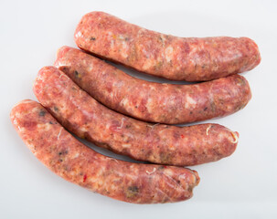 Raw farm sausages with mushrooms on white background