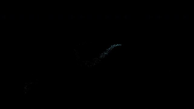 A collection of glowing blue stardust trails with star particles is isolated on a black background featuring an alpha channel.
