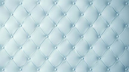 A close-up of a quilted, light blue fabric with a textured pattern.
