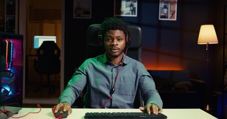 Man broadcasting gaming session online, talking with audience while destroying enemies to finish level in multiplayer game. Gamer streaming live esports online videogame, chatting with fans