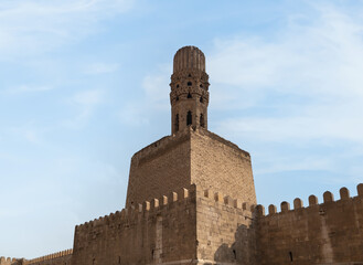  View of Al-Hakim Mosque in Cairo, Showcasing the Famous Minaret and part of the ancient City walls. © TRAVEL MOSAIC