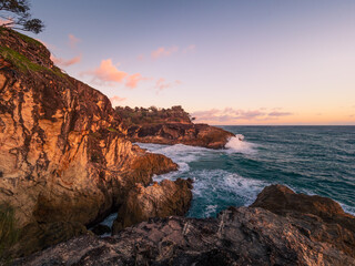 Waves Crashing on Rocky Headland in the Morning