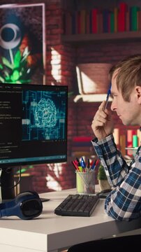 AI software developer at computer waiting for code to finish compiling, rubbing forehead with pen, feeling bored. Impatient man waits for artificial intelligence scripts to finish compiling, camera A
