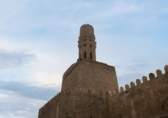 Al-Hakim Mosque minaret with stone fortification in Old Cairo.