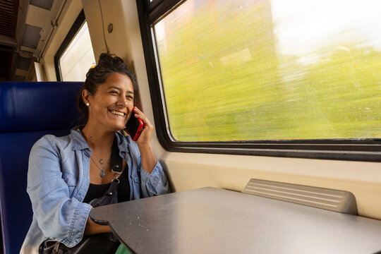 Joyful Train Journey, Woman Enjoys Phone Call While Traveling