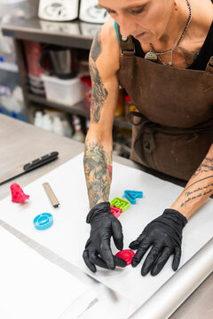 Artisan preparing colorful fondant decorations in bakery