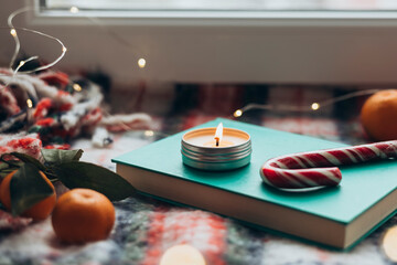 Intimate Christmas setting with candle and festive treats