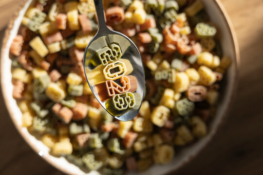 Spoon holding number shaped pasta for the year 2026
