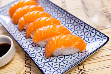 Nigiri sushi with salmon. Delicious traditional Japanese food, tasty seafood, restaurant concept, food background
