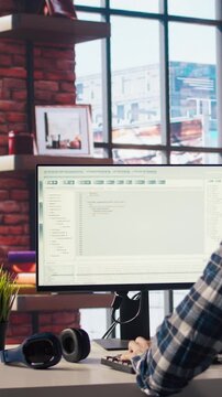 Software developer at computer coding, creating software, implementing algorithms. IT expert in home office working with code editor, building applications, optimizing performance, camera A