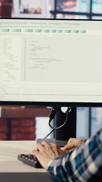 Man in home office looks at green screen tablet and computer, typing and executing programming code. Coding application used by IT developer writing and testing code using chroma key device, camera B