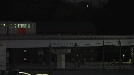 Tokyo,Japan - December 16,  2024: A monorail train passing at dawn in Tokyo, Japan