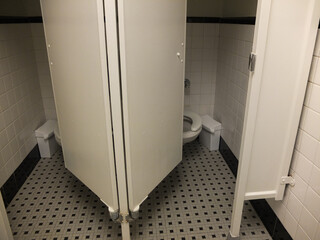 white toilet booths with tiled floor