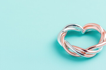 Fototapeta premium Heart shaped jewelry with intertwining silver and rose gold design