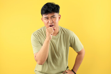 Young Asian Man Coughing into His Fist