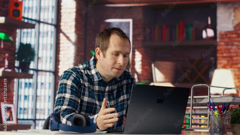 Poster manager calls employee remotely using internet videocall to offer negative feedback on project progr