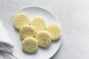 tuwon madara on a white plate, nigerian alawar madara milk candy, top view of milk fudge on a white ceramic plate