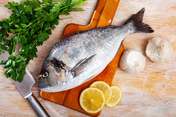 Whole dorado fish on wooden surface. High quality photo