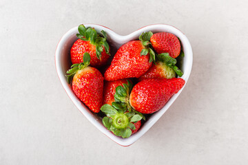 Fresh strawberries in heart bowl