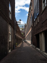 Narrow street in the city of Amsterdam. Lights and shadows. Netherlands