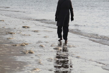 Image of people walking barefoot at Dadaepo Beach in Busan
