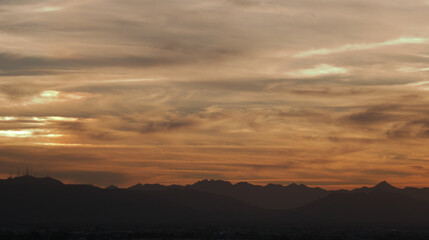 Desert Skies with swirls of clouds at golden hour.