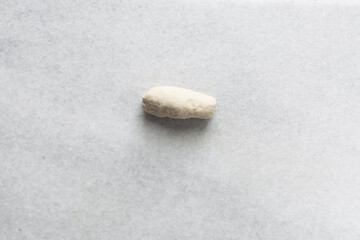Obraz premium Overhead view of noodles dough on a marble countertop, top view of homemade biang biang noodles dough, process of making hand pulled noodles