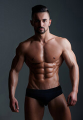 Fototapeta premium Topless man with muscle. Sexy male body. Handsome sexy model. Shirtless muscled male model. Man with a naked torso. Muscular young man with perfect body stripping. Sexy man. Seductive guy.