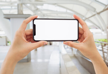 Hand holding smartphone mockup of blank screen, Take your screen to put on advertising.