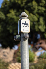 A traffic light button for horses to manage the flow of equestrian traffic, ensuring safety and efficiency wherever horses and riders cross paths with vehicles. 