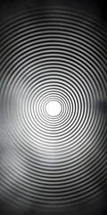 A mesmerizing black and white image featuring concentric circles, gradually leading to a bright center, creating a hypnotic and calming effect.