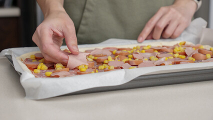 Homemade square pizza with cheese and sausage topping served on wooden table Square pizza, full cheese spread organic pizza healthy pizza