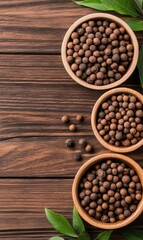 Assorted Whole Spices in Wooden Bowls on Rustic Wooden Background with Fresh Green Leaves