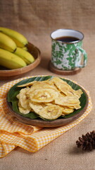 Indonesian banana chips on a wooden bowl with a traditional property theme photographed with studio light