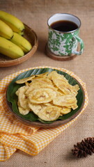 Indonesian banana chips on a wooden bowl with a traditional property theme photographed with studio light