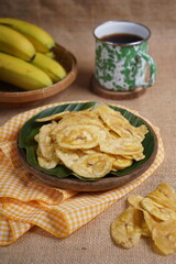 Indonesian banana chips on a wooden bowl with a traditional property theme photographed with studio light