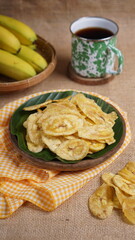Indonesian banana chips on a wooden bowl with a traditional property theme photographed with studio light