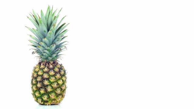 Rotating pineapple loop. 55 second slow motion spinning pineapple. Isolated on a white background.