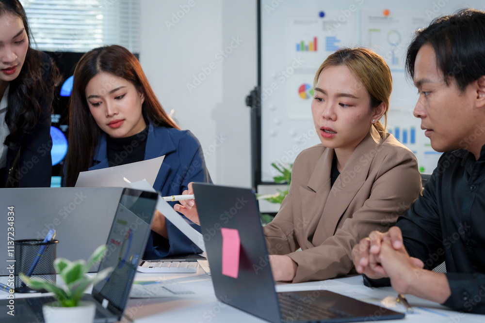 Poster business team analyzing financial data and discussing project strategy during a meeting in the offic