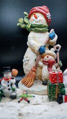 Christmas decorations, ointments, miniatures, trees, people with background of snow and rocks