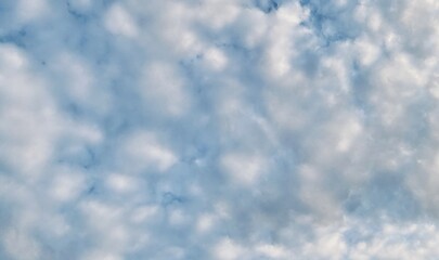 Beautiful sky with fluffy white clouds, soft and serene atmosphere, perfect for a clear and peaceful day