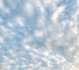 Beautiful sky with fluffy white clouds, soft and serene atmosphere, perfect for a clear and peaceful day