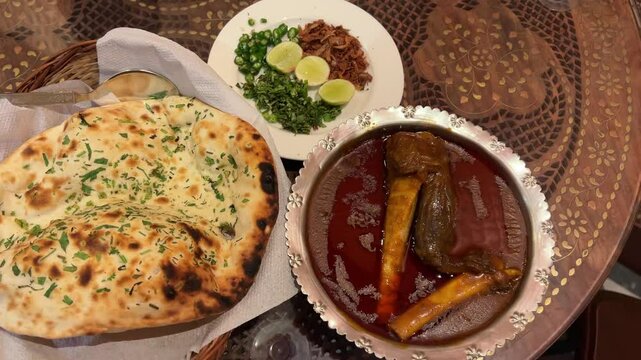 Indian cuisine of naan and mutton Nalli Nihari served at a restaurant names Man o salva in India.