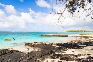 Serene Tropical Beach with Crystal Clear Waters and Rocky Shoreline, Mauritius