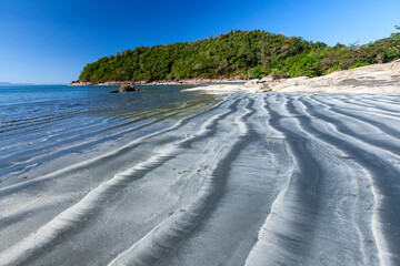 The black sand beach on a sunny summer.